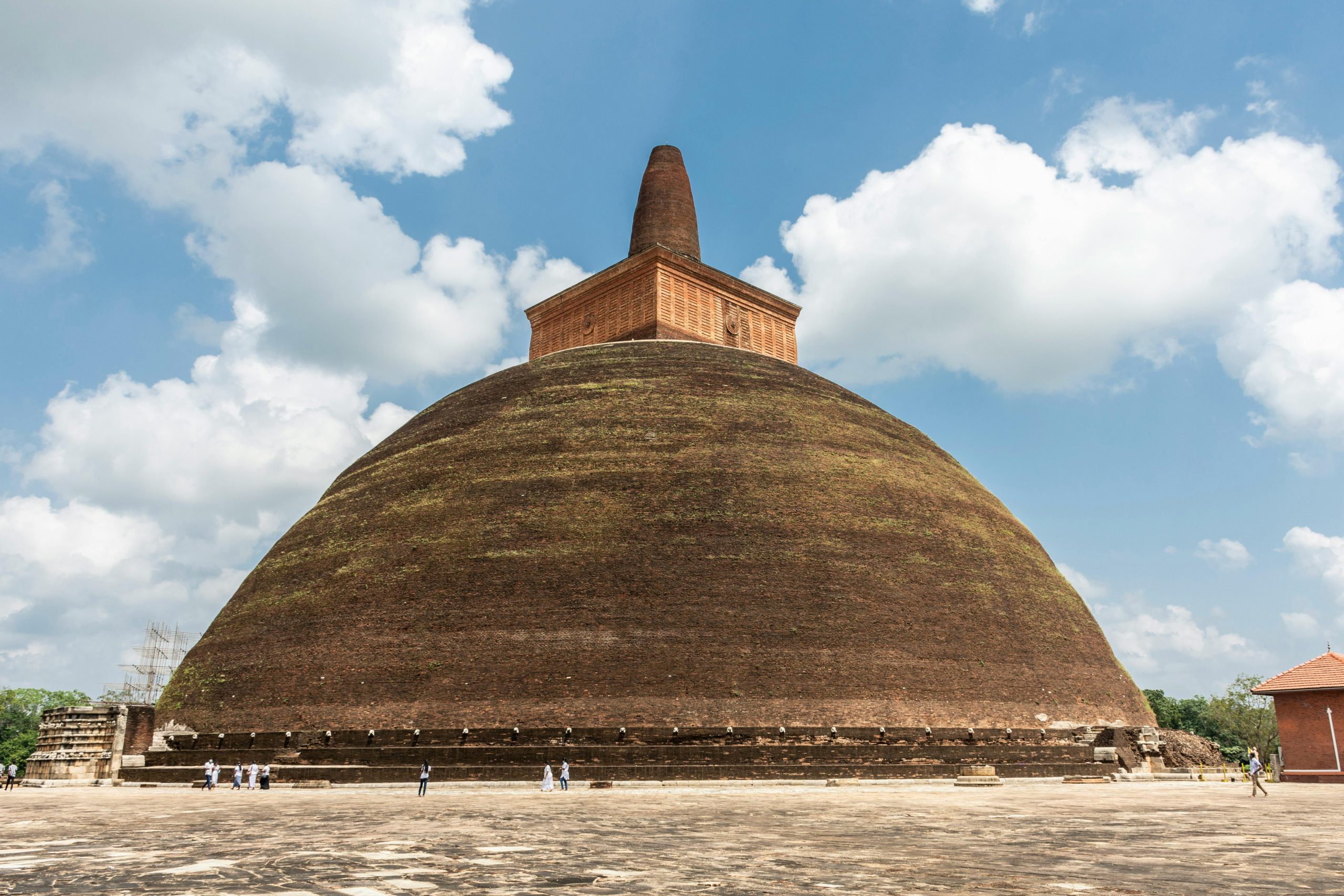 Explore the ancient Abhayagiri Stupa in Anuradhapura under a clear blue sky.
